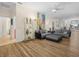 Open-concept living room featuring hardwood floors, a large gray sectional, and stylish decor at 4148 Dunmore Dr, Lake Wales, FL 33859