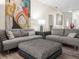 Comfortable living room with gray sectional sofa, stylish ottoman, and eye-catching artwork at 4148 Dunmore Dr, Lake Wales, FL 33859