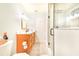 Well-lit bathroom with a wood vanity, tile floors, and glass shower with a grab bar at 4228 Nandina St, Lake Wales, FL 33898