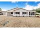 Well-maintained home with red shutters, a convenient carport, and beautiful white gravel landscaping at 4228 Nandina St, Lake Wales, FL 33898