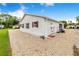 Charming white home featuring red shutters and rock landscaping for easy maintenance at 4228 Nandina St, Lake Wales, FL 33898