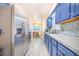 Modern kitchen with stainless steel appliances, blue cabinets, tile backsplash and flooring and eat-in dining area at 4228 Nandina St, Lake Wales, FL 33898