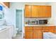 Bright laundry area with cabinets, countertop space, laundry and access to a half bath at 4228 Nandina St, Lake Wales, FL 33898