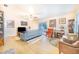 Bright living room features wood floors, ceiling fan, slider to the back yard and a comfortable seating arrangement at 4228 Nandina St, Lake Wales, FL 33898