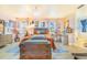 Bright main bedroom features soft colors, windows with decorative curtains, and a comfortable bed at 4228 Nandina St, Lake Wales, FL 33898