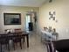 Open dining room featuring tile floors, a modern light fixture, and view to patio at 423 Greenfield Rd, Winter Haven, FL 33884