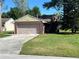 Charming single-story home with a well-maintained lawn and attached two-car garage at 423 Greenfield Rd, Winter Haven, FL 33884
