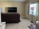 Cozy living room with tile flooring, large window, and comfortable seating at 423 Greenfield Rd, Winter Haven, FL 33884
