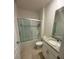 Bathroom featuring a granite countertop vanity with a single sink and tub with a glass enclosure at 4333 Pumice Dr, Lakeland, FL 33811