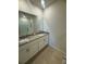 Bathroom with a granite countertop vanity and dual sinks, complemented by tiled floors and a shower at 4333 Pumice Dr, Lakeland, FL 33811
