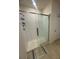 Bathroom featuring a modern glass-enclosed shower with white tiled walls and tiled floor at 4333 Pumice Dr, Lakeland, FL 33811