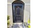 The front entryway has a secure screen door and leads to a shaded porch with an arched entryway at 4333 Pumice Dr, Lakeland, FL 33811