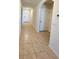 Bright hallway featuring tile flooring with the front door, and an arched doorway visible at 4333 Pumice Dr, Lakeland, FL 33811