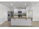 Well-lit kitchen featuring white cabinetry, granite counters, a large island and stainless steel appliances at 4333 Pumice Dr, Lakeland, FL 33811