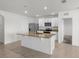 Bright kitchen features white cabinetry, granite counters, an island and stainless steel appliances at 4333 Pumice Dr, Lakeland, FL 33811