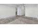 Carpeted living room with neutral walls and view into the kitchen area at 4333 Pumice Dr, Lakeland, FL 33811