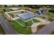 Aerial view of a fenced in property with a well-kept lawn and backyard with various outdoor amenities at 498 W 7Th St, Frostproof, FL 33843