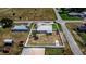 Aerial view of a property with fenced yard, showing its layout and proximity to nearby homes and streets at 498 W 7Th St, Frostproof, FL 33843