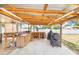 The backyard has a covered outdoor cooking area, complete with counters, storage, and grill space at 498 W 7Th St, Frostproof, FL 33843