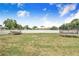 Wide view of the backyard with a boat, trampoline, and privacy fence at 498 W 7Th St, Frostproof, FL 33843