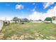 Large backyard showcasing a trampoline, boat, shed, and privacy fence, ideal for outdoor activities at 498 W 7Th St, Frostproof, FL 33843