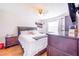 Bright bedroom featuring a ceiling fan, wood floors, and traditional furnishings at 498 W 7Th St, Frostproof, FL 33843
