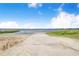 Concrete boat ramp leading into the serene lake with beach and grassy areas surrounding it at 498 W 7Th St, Frostproof, FL 33843