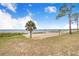 Community beach with sandy shore, palm tree, picnic area, and stunning lake views at 498 W 7Th St, Frostproof, FL 33843