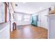 Welcoming entryway with hardwood floors, bench and ample natural light at 498 W 7Th St, Frostproof, FL 33843