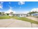 Quaint home featuring a beautiful lawn, quaint front porch, and an attached one car garage at 498 W 7Th St, Frostproof, FL 33843