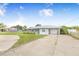 Charming single-story home with a well-maintained lawn and a long driveway leading to the attached garage at 498 W 7Th St, Frostproof, FL 33843