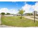 Beautifully landscaped front yard with a well-manicured lawn and vibrant tropical foliage at 498 W 7Th St, Frostproof, FL 33843