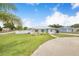 Lovely home with a lush front yard and mature palm trees, offering great curb appeal at 498 W 7Th St, Frostproof, FL 33843