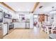 Open concept kitchen features stainless appliances, tile floors, wooden beams and a breakfast nook at 498 W 7Th St, Frostproof, FL 33843