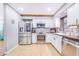 Bright eat-in kitchen features stainless appliances, wooden beams and tile floors at 498 W 7Th St, Frostproof, FL 33843
