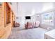 Open living room with wooden floors, panelled walls, white trim, fireplace and recliners at 498 W 7Th St, Frostproof, FL 33843