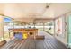 View of the covered patio with wooden bar, table and chairs, and backyard access with a view of the backyard at 498 W 7Th St, Frostproof, FL 33843