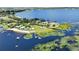 Aerial view showcasing the lakefront property with lush surroundings and private docks on the water at 553 Thornburg Rd, Babson Park, FL 33827