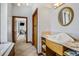 Bright bathroom featuring a unique sink design, ample storage, and a doorway leading to additional areas of the home at 553 Thornburg Rd, Babson Park, FL 33827