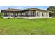 Exterior of home with screened lanai perfect for entertaining and enjoying the outdoors at 553 Thornburg Rd, Babson Park, FL 33827