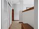Hallway with sliding closet door, baseboard trim, neutral carpet and white walls, and a wooden storage chest at 553 Thornburg Rd, Babson Park, FL 33827