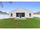 View of the backyard and screened in patio with furniture at 59 Saint Kitts Cir, Winter Haven, FL 33884