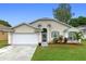 Charming single-story home with a two-car garage, beautiful landscaping, and a well-maintained lawn at 59 Saint Kitts Cir, Winter Haven, FL 33884