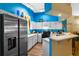 Bright kitchen with white cabinetry, stainless steel appliances, and a view into the dining area at 59 Saint Kitts Cir, Winter Haven, FL 33884