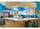 Colorful kitchen with white cabinets, appliances, and a breakfast bar area at 59 Saint Kitts Cir, Winter Haven, FL 33884