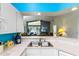 Bright kitchen with white cabinets and stainless steel sink open to the living room at 59 Saint Kitts Cir, Winter Haven, FL 33884