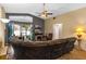 Open living room with a large sofa, television, fireplace, and view of the outdoor space at 59 Saint Kitts Cir, Winter Haven, FL 33884
