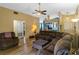 Cozy living room with comfortable seating, fan, and view of kitchen at 59 Saint Kitts Cir, Winter Haven, FL 33884