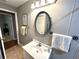 Bright bathroom featuring a vanity, stylish mirror, and convenient towel rack at 605 Wanamaker Ave, Fort Meade, FL 33841
