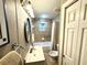 Bathroom with tiled shower/tub combo, vanity, and convenient accessories at 605 Wanamaker Ave, Fort Meade, FL 33841